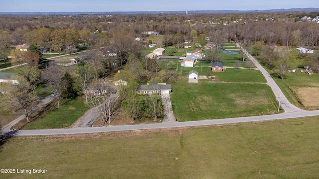 birds eye view of property featuring a wooded view