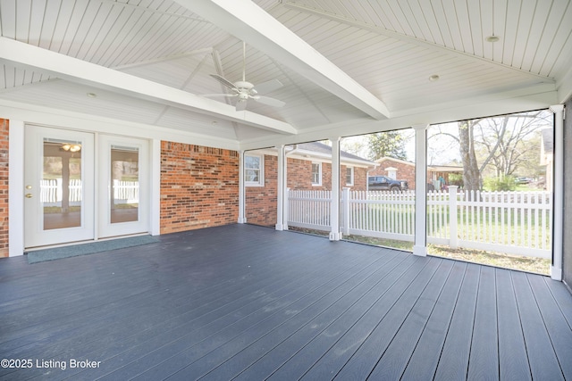 unfurnished sunroom with beam ceiling and ceiling fan