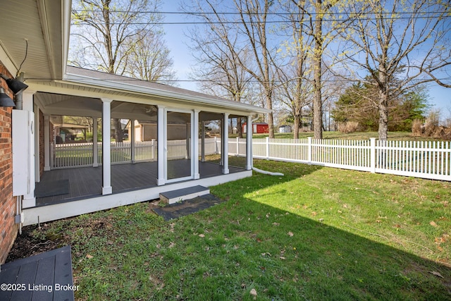 view of yard with a sunroom and fence private yard