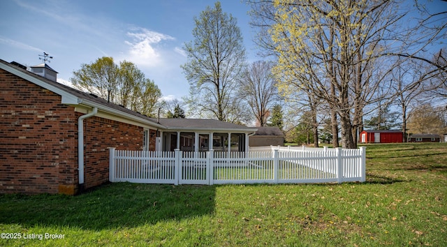 view of yard with a sunroom and fence