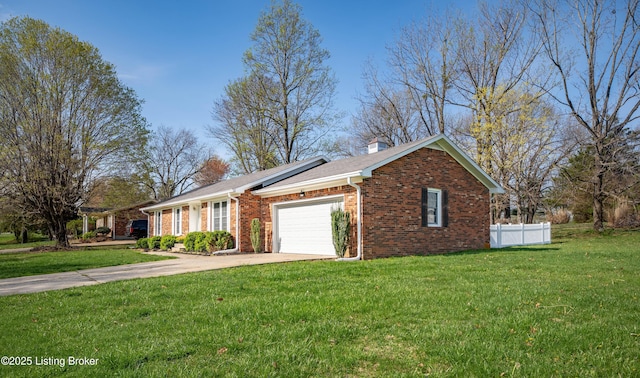 view of front of property featuring a front yard, an attached garage, a chimney, concrete driveway, and brick siding