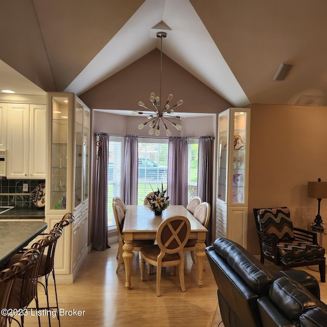 404 Eastgate Village Wynde, Louisville, KY 40223 - dining room featuring light wood finished floors, an inviting chandelier, and lofted ceiling