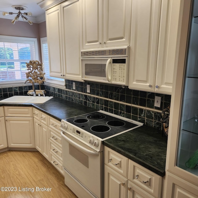 404 Eastgate Village Wynde, Louisville, KY 40223 - kitchen with a sink, backsplash, dark countertops, and white appliances