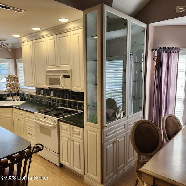 404 Eastgate Village Wynde, Louisville, KY 40223 - kitchen featuring white appliances, dark countertops, visible vents, decorative backsplash, and a sink