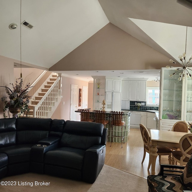 404 Eastgate Village Wynde, Louisville, KY 40223 - living area with visible vents, ornamental molding, vaulted ceiling, stairs, and light wood-style flooring