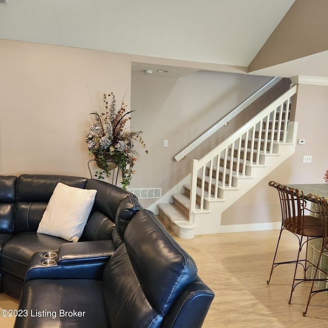 404 Eastgate Village Wynde, Louisville, KY 40223 - living area featuring vaulted ceiling, visible vents, stairway, wood finished floors, and baseboards