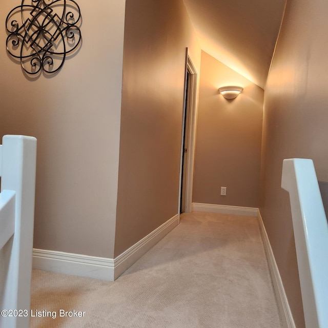 404 Eastgate Village Wynde, Louisville, KY 40223 - hall with carpet floors, baseboards, an upstairs landing, and lofted ceiling