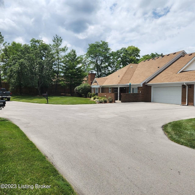 404 Eastgate Village Wynde, Louisville, KY 40223 - exterior space featuring a chimney, an attached garage, aphalt driveway, brick siding, and a lawn