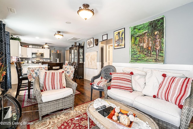 living room featuring visible vents and wood finished floors
