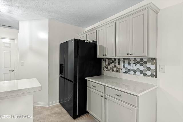 1112 Majestic Woods Dr, La Grange, KY 40031 - kitchen featuring black refrigerator with ice dispenser, backsplash, light countertops, baseboards, and a textured ceiling