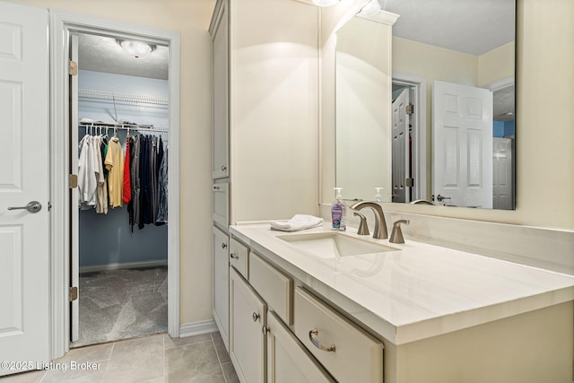 1112 Majestic Woods Dr, La Grange, KY 40031 - bathroom with vanity, baseboards, a spacious closet, and tile patterned flooring