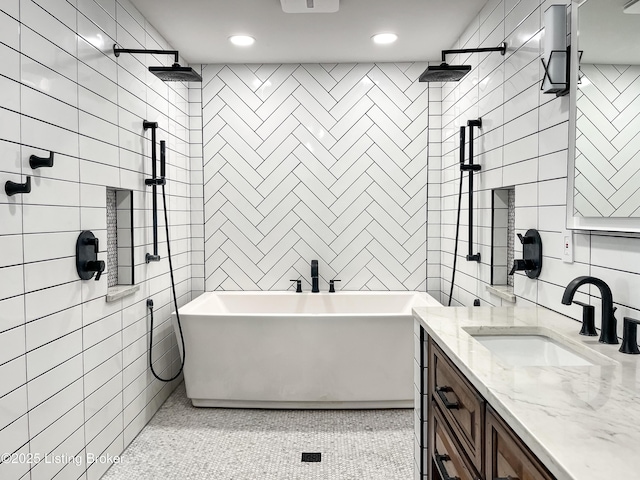 119 Fairway Dr, Hodgenville, KY 42748 - full bathroom featuring a tile shower, a freestanding bath, vanity, and tile walls