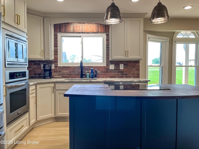 119 Fairway Dr, Hodgenville, KY 42748 - kitchen featuring a sink, tasteful backsplash, appliances with stainless steel finishes, and a healthy amount of sunlight
