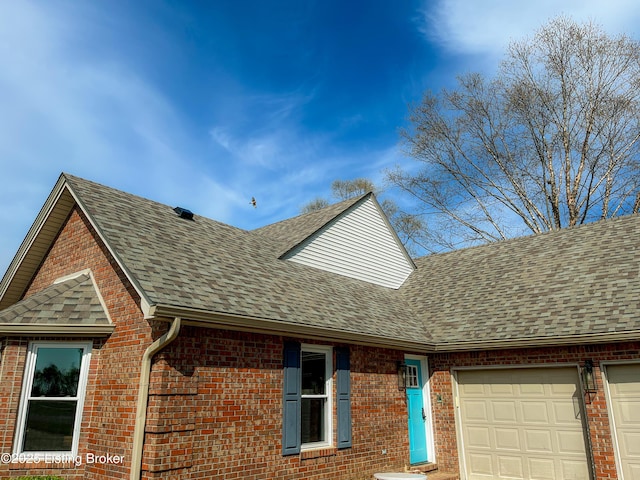 119 Fairway Dr, Hodgenville, KY 42748 - exterior details featuring a shingled roof, gutters, brick siding, and a downspout