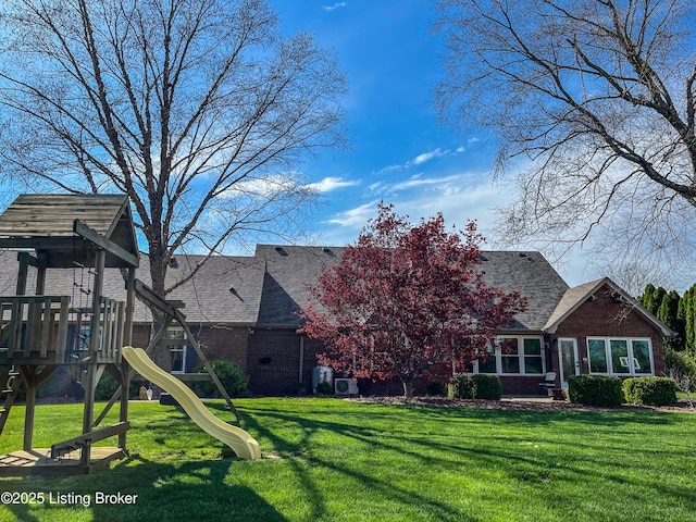 119 Fairway Dr, Hodgenville, KY 42748 - back of house featuring brick siding, a lawn, a playground, and roof with shingles