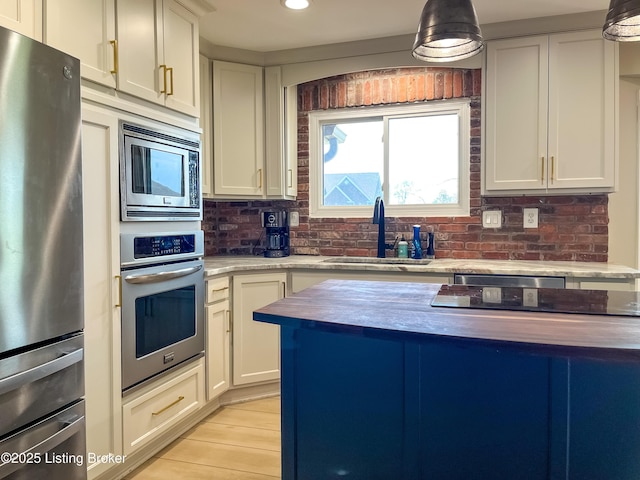 119 Fairway Dr, Hodgenville, KY 42748 - kitchen with white cabinetry, a sink, butcher block countertops, and appliances with stainless steel finishes