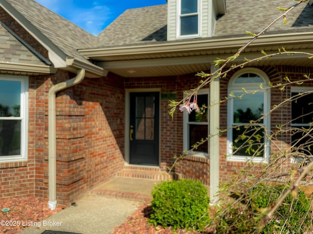 119 Fairway Dr, Hodgenville, KY 42748 - view of exterior entry with brick siding, a shingled roof, and covered porch