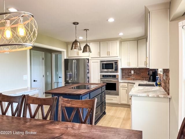 119 Fairway Dr, Hodgenville, KY 42748 - kitchen with stainless steel appliances, light wood-style flooring, backsplash, white cabinetry, and wooden counters