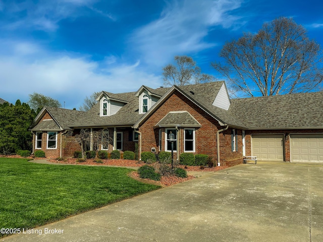 119 Fairway Dr, Hodgenville, KY 42748 - cape cod-style house with a shingled roof, driveway, brick siding, and a front lawn