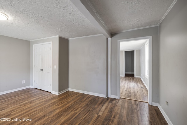 interior space with dark wood-type flooring, a textured ceiling, and baseboards