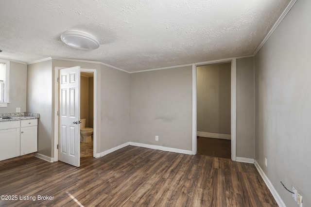 interior space featuring a textured ceiling, baseboards, and dark wood-style flooring
