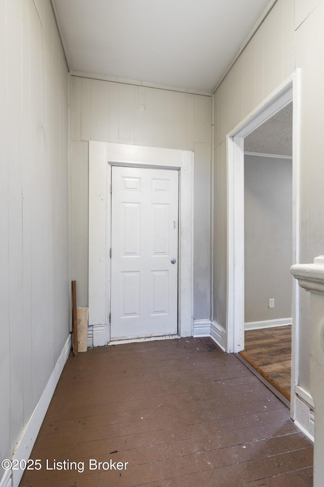 entrance foyer with hardwood / wood-style flooring and wood walls