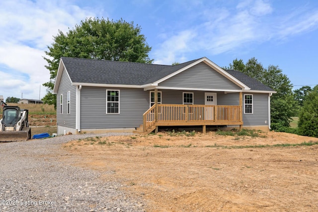 3408 Rhodelia Rd, Payneville, KY 40157 - ranch-style home with roof with shingles, a deck, and gravel driveway