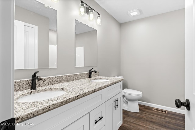 3408 Rhodelia Rd, Payneville, KY 40157 - bathroom featuring double vanity and wood finished floors