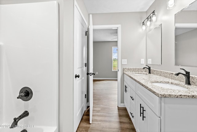 3408 Rhodelia Rd, Payneville, KY 40157 - bathroom with double vanity, wood finished floors, and bathtub / shower combination