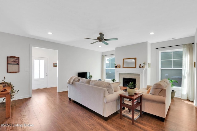 living room with ceiling fan, a fireplace, dark wood finished floors, and recessed lighting