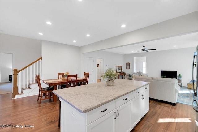 kitchen with a center island, wood finished floors, and recessed lighting