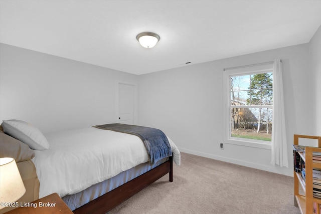 bedroom with visible vents, baseboards, and light colored carpet