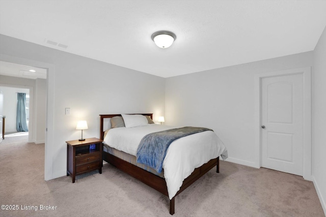 bedroom with visible vents, light colored carpet, and baseboards