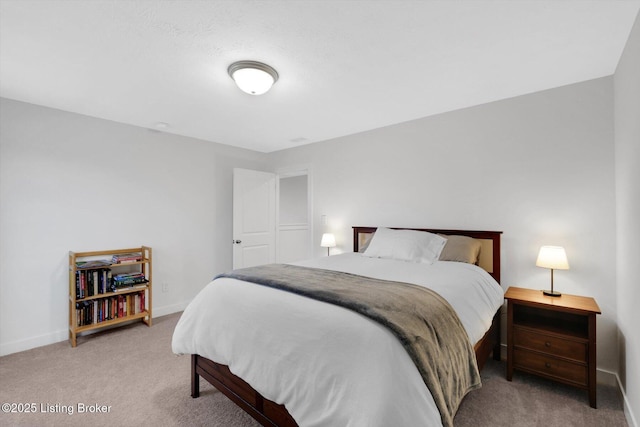 bedroom featuring light carpet and baseboards