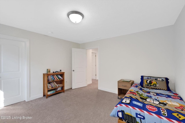 bedroom with baseboards and carpet