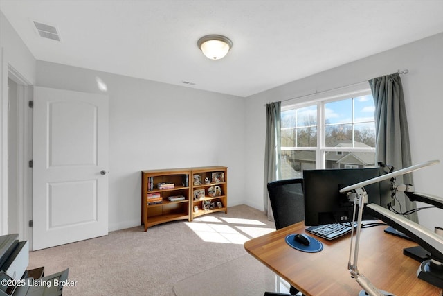 home office with carpet flooring, baseboards, and visible vents