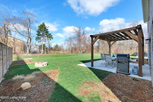 view of yard with a pergola, a patio, a fire pit, and fence