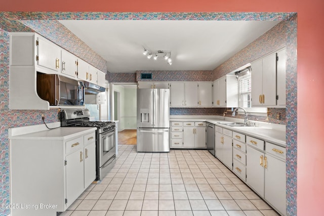 kitchen featuring light countertops, appliances with stainless steel finishes, a sink, and visible vents