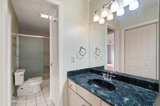 full bath with a shower stall, vanity, tile patterned flooring, and toilet