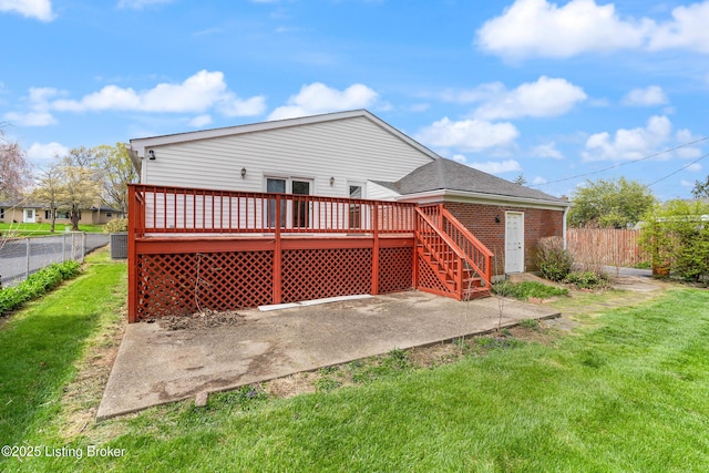 rear view of house featuring central AC, a deck, fence private yard, and a lawn