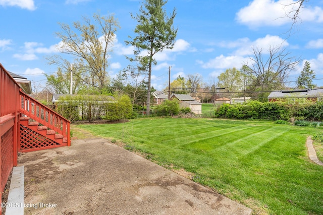 view of yard featuring fence and a patio