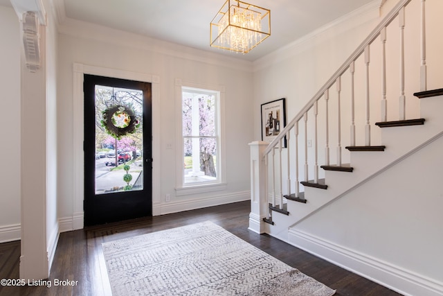 foyer entrance featuring crown molding, wood finished floors, baseboards, and stairs