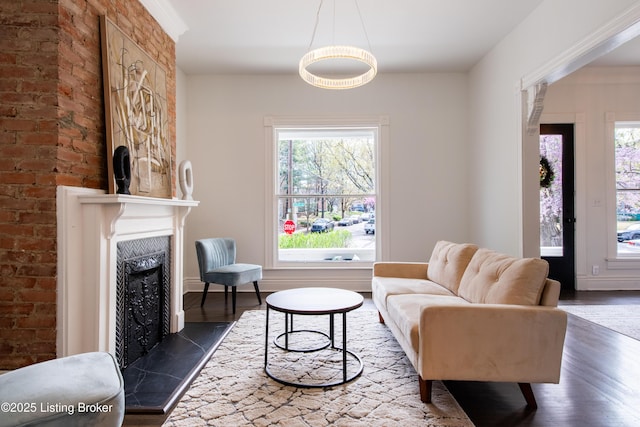 living room with a fireplace, dark wood finished floors, and plenty of natural light