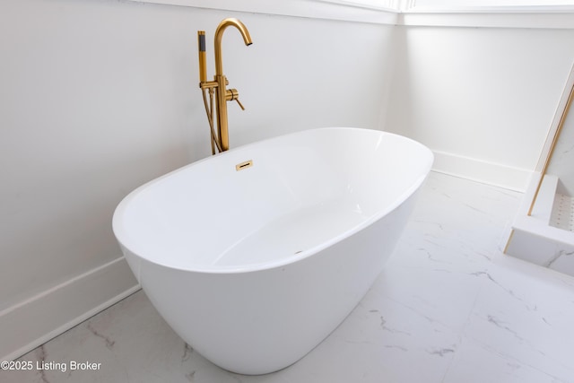 room details with a freestanding tub and baseboards