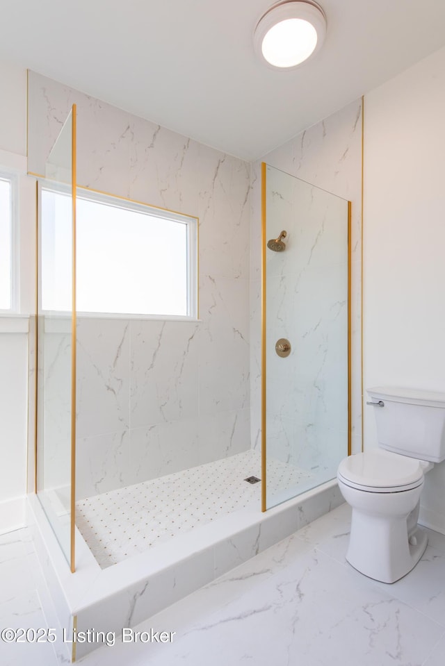 full bathroom with marble finish floor, a marble finish shower, and toilet