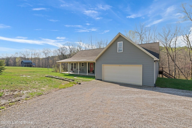 351 Serenity Cove Ln, Mammoth Cave, KY 42259 - view of front facade featuring roof with shingles, dirt driveway, a front yard, a porch, and a garage