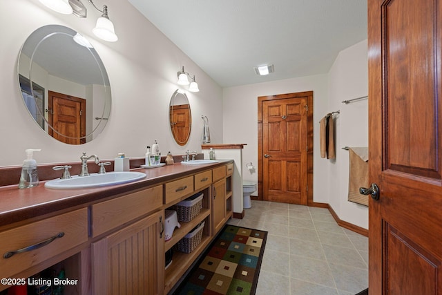 351 Serenity Cove Ln, Mammoth Cave, KY 42259 - bathroom featuring toilet, double vanity, a sink, and baseboards