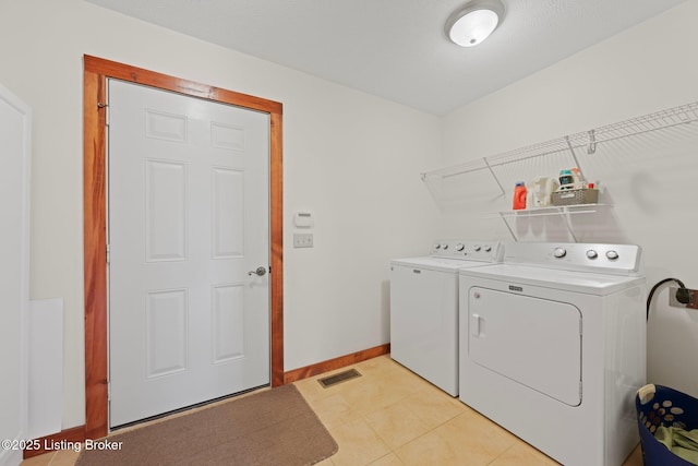 351 Serenity Cove Ln, Mammoth Cave, KY 42259 - laundry room with baseboards, light tile patterned flooring, visible vents, independent washer and dryer, and laundry area