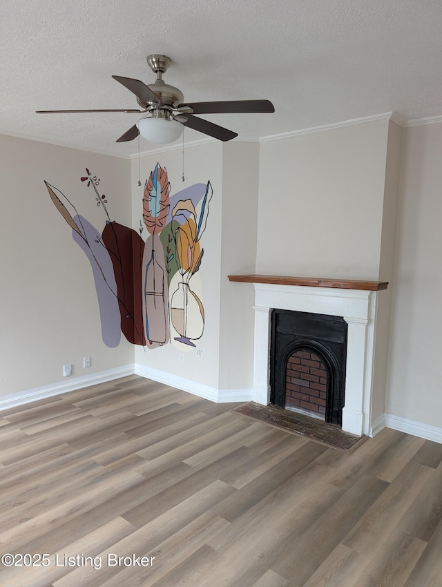 unfurnished living room featuring a textured ceiling, wood finished floors, ceiling fan, and ornamental molding