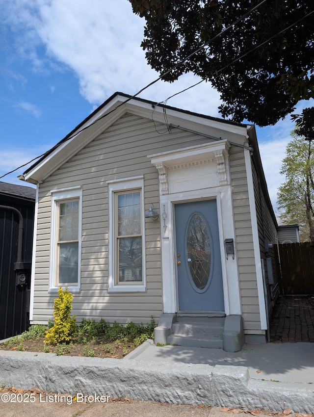 view of front of house with entry steps and fence